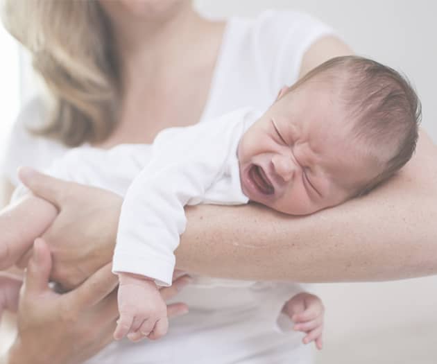 Woman holding crying baby