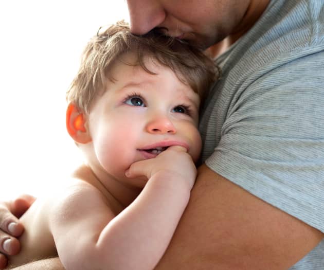 young boy cuddled up to his father