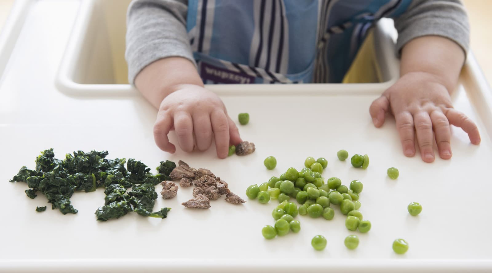 Baby playing with food