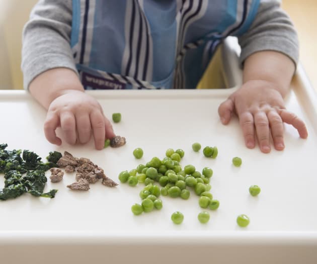 Baby playing with food