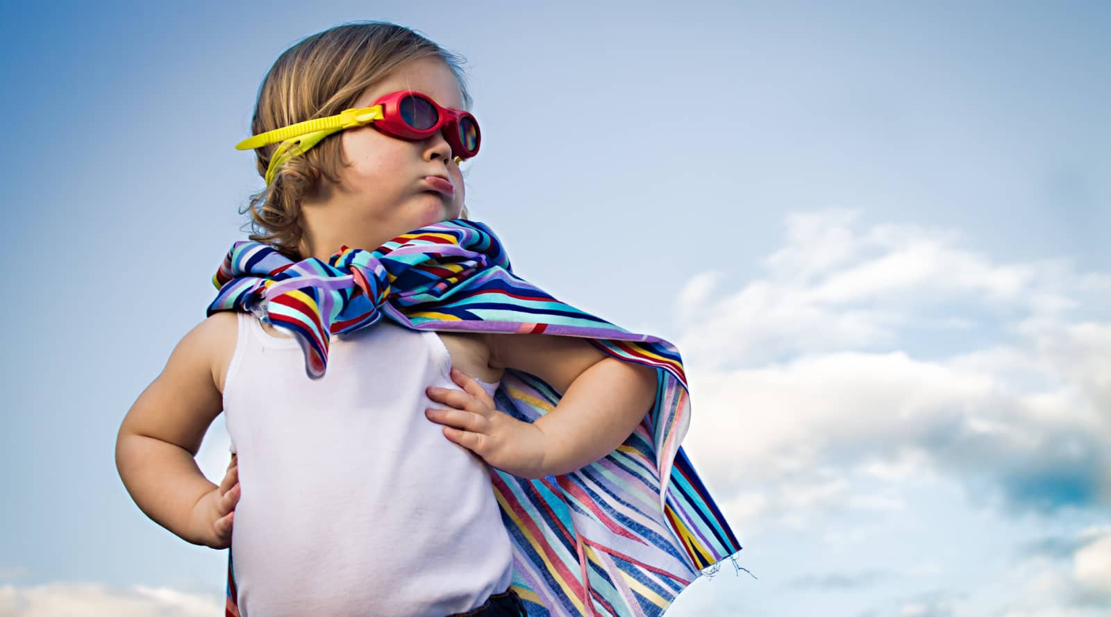 Toddler with cape and goggles