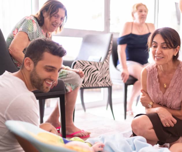 Family gathering around a newborn