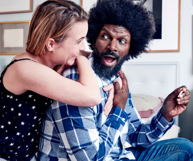 Couple reacting happily to pregnancy test