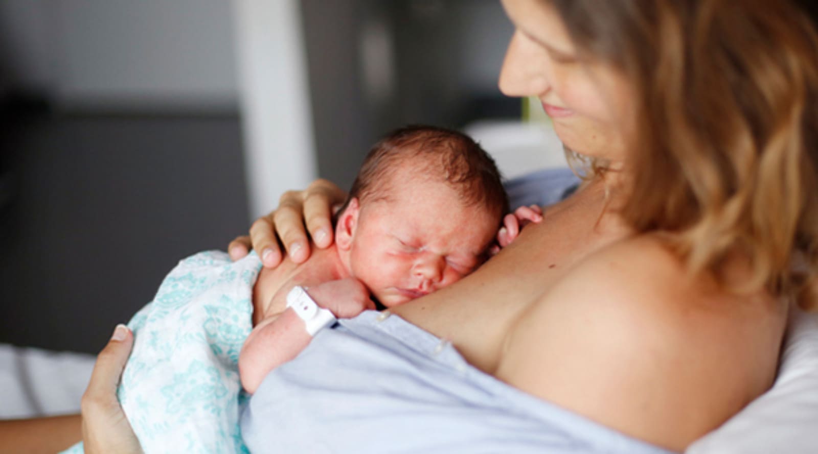 mother-holding-newborn-on-chest