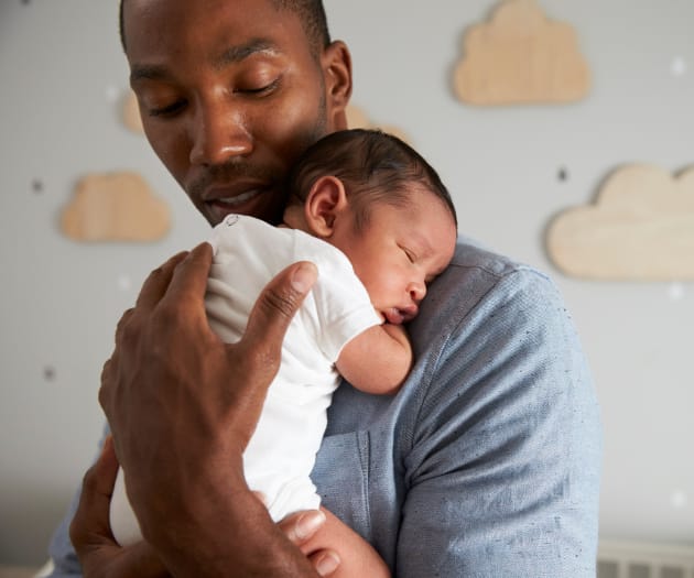 parent holding a newborn baby