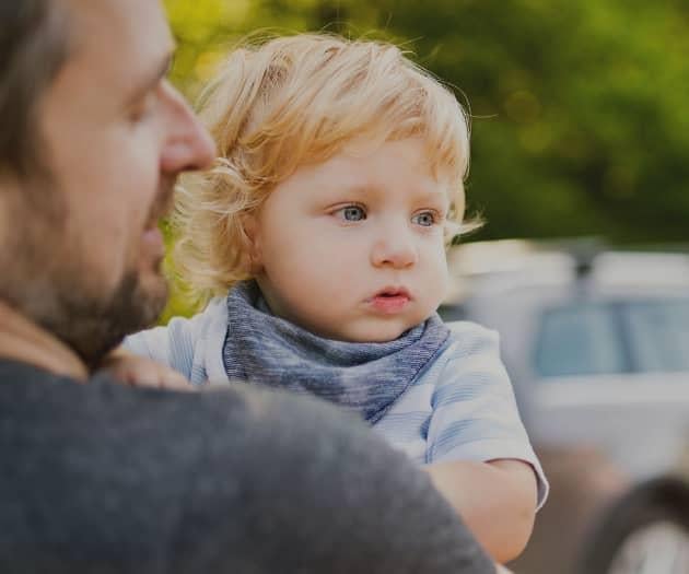 Father carrying toddler