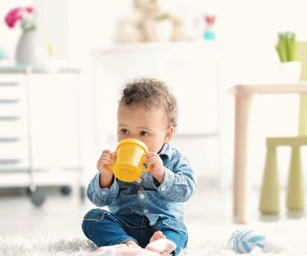 Baby drinking from beaker